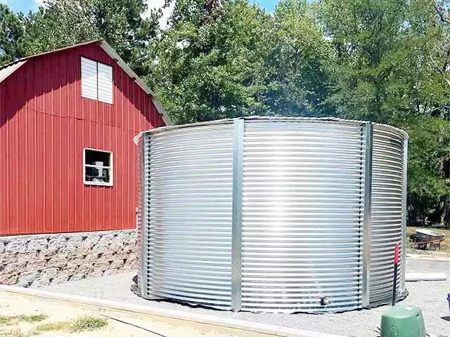 Corrugated tank next to a red house