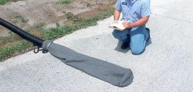 Filter sock attached to a discharge hose for sediment control