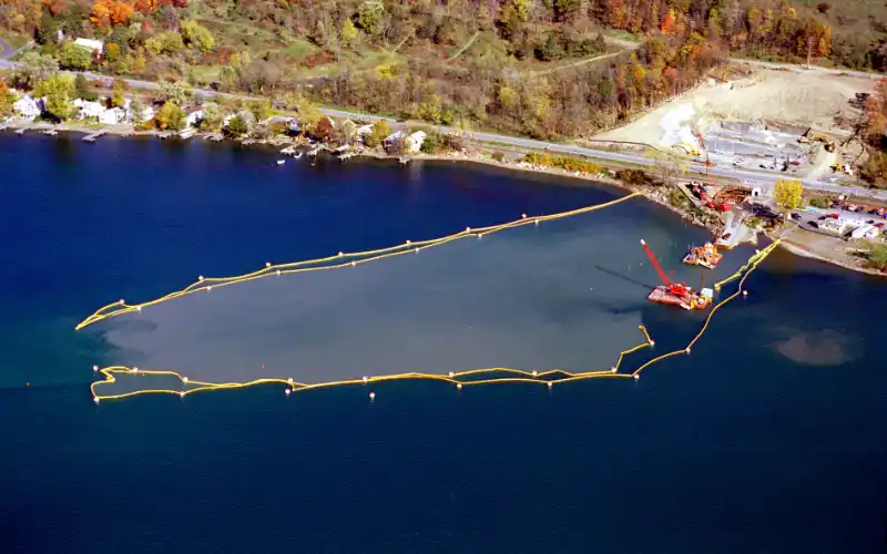 Permanent debris boom protecting shoreline and infrastructure