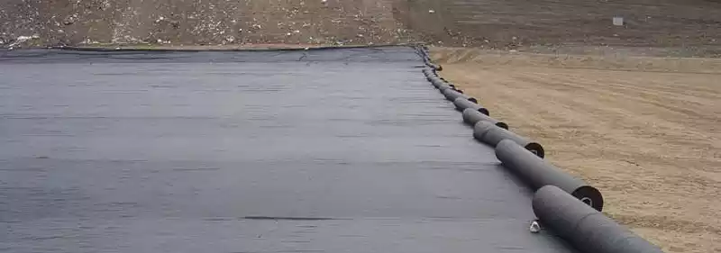 Multiple rolls of Mirafi Non-Woven Geotextile being deployed