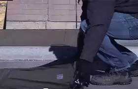 Man laying down concrete curing blanket