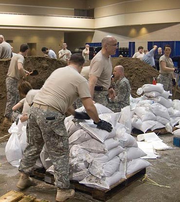 filling sandbags for flood defense