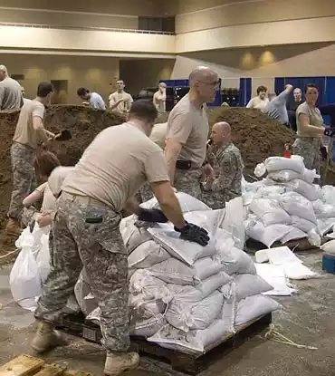 filling sandbags for flood defense