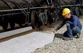 Man using Ultra Rail Mat on train tracks